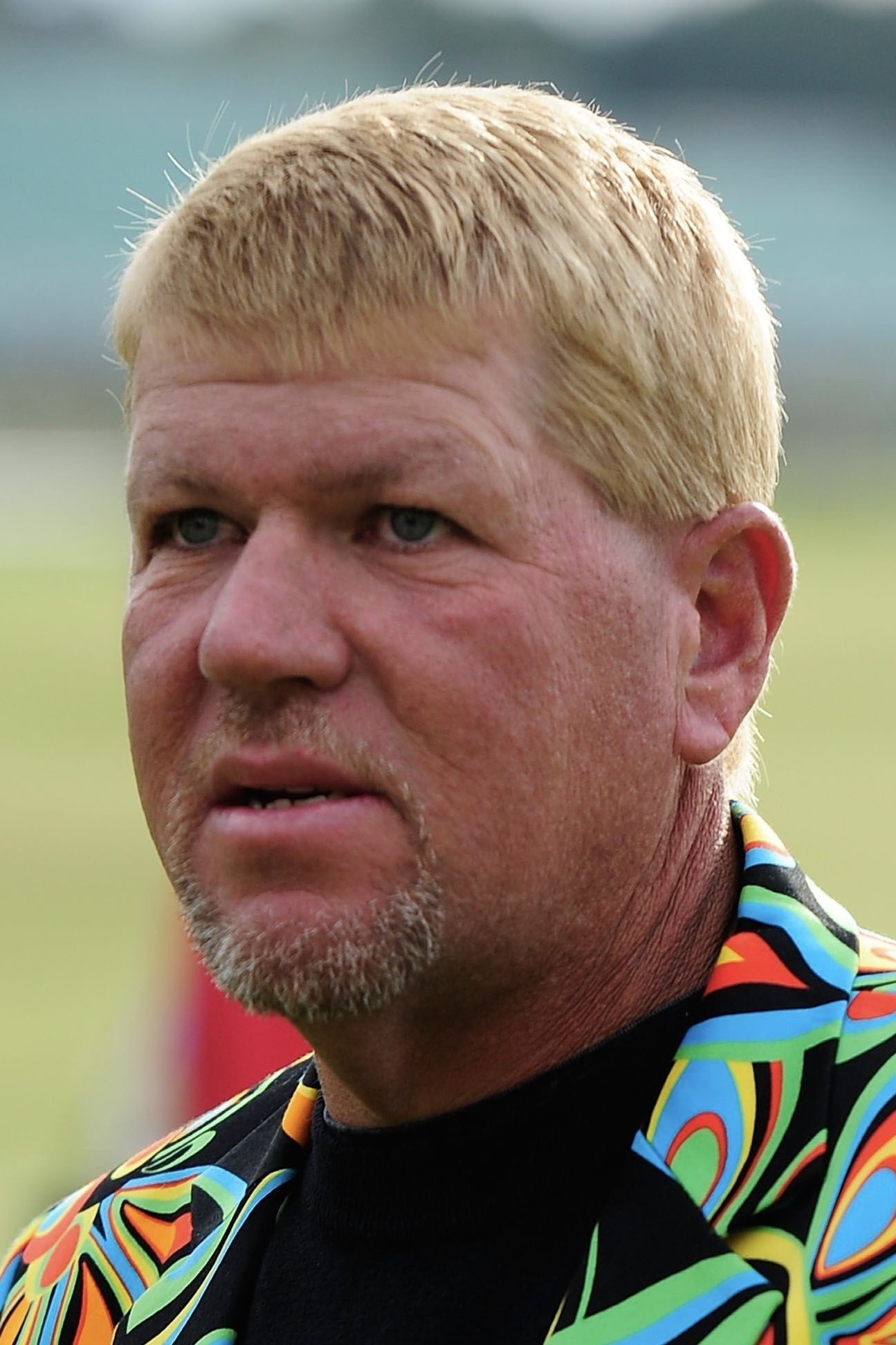 A headshot of John Daly.