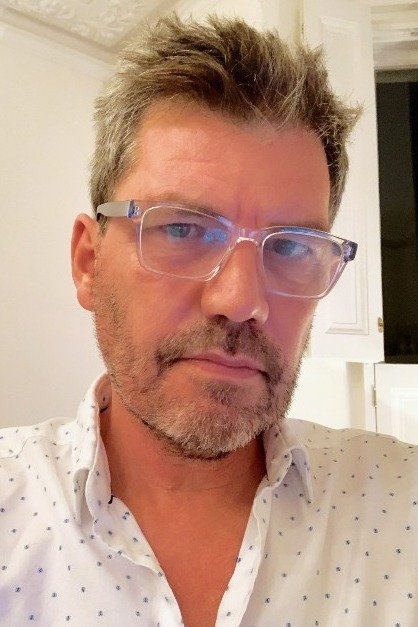 A headshot of Marcus Rowland.