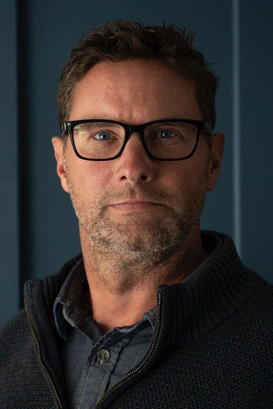 A headshot of John Collins.