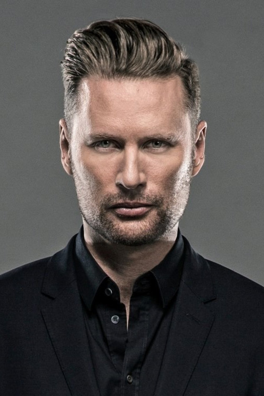A headshot of Brian Tyler.