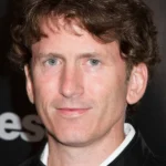Headshot for Todd Howard, featuring a Bethesda background